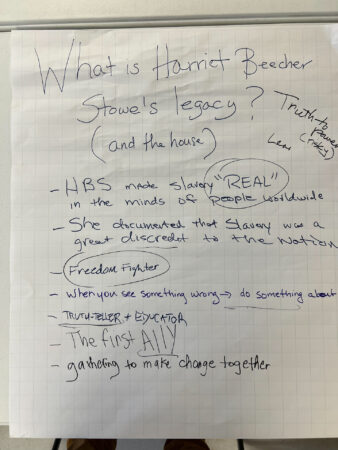 A handwritten brainstorm about Harriet Beecher Stowes legacy on a large sheet of paper with various notes.